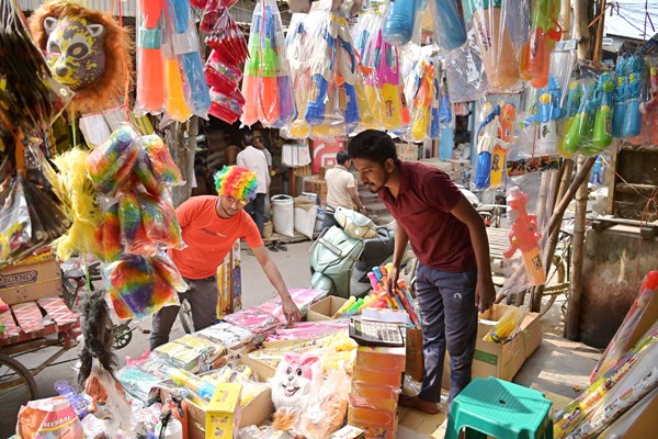 A man is busy buying colors before the auspicious celebration of Holi festival from a shop at MG Bazar area of Agartala on March 1st.