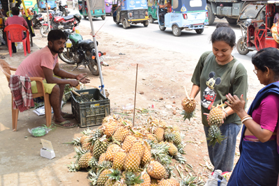 People buying delicious pineapple amidst sweltering heat at Agartala on May 23.
