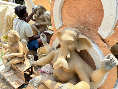 A clay artisan giving final touches to clay made idols of Lord Ganesha at his studio in Agartala on September 8.  