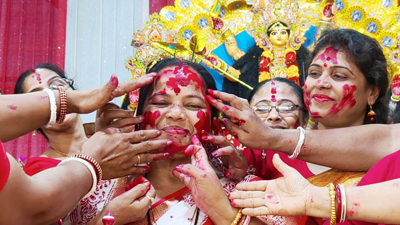 Women devotees apply vermilion on each other on the occasion of Dashami festival at a temple in Agartala on March 28.