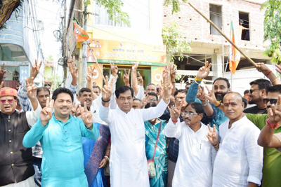 Mayor of Agartala Municipal Corporation (AMC) Dipak Majumder celebrates with party workers after landslide victory of BJP in Bengal polls on May 4.