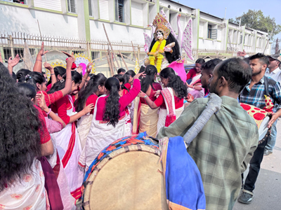 The school students are joyfully carrying the idol of Goddess Saraswati to their school at Agartala on the eve of the worship of Goddess.