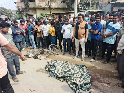 Police and local residents gather at the site of a fatal road accident at Mayalakhala area on the outskirts of Agartala city on February 26, where one person lost his life. 