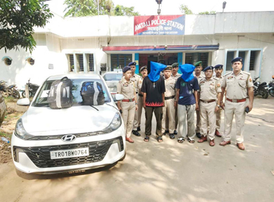 Police arrest two persons and seize a car at Amtali Police Station in Agartala on September 30. 