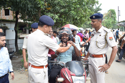 West Agartala police station in collaboration with an insurance company distributes helmets among two-wheeler riders at Battala area of the city on September 9.
